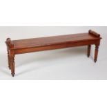A Victorian style elm window seat, having scroll ends and on turned and tapering reeded supports, w.