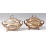 A pair of late George III silver tureens and covers, of squat oval half-gadrooned form,