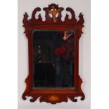 A 19th century walnut framed fret carved wall mirror, in the Chippendale style,