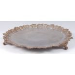 A George IV heavy silver salver, having a C-scroll and acanthus leaf cast piecrust rim,