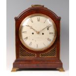 A George III mahogany dome-top bracket clock, having a convex white enamel dial,