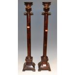 A pair of large painted brass ecclesiastical style table candlesticks, h.