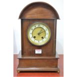 An early 20th century Continental walnut cased mantel clock,