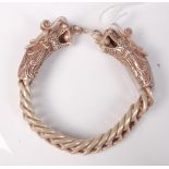 A Chinese white metal bracelet with double dragon head style clasp,