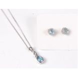 A 9ct white gold topaz and diamond pendant and a pair of topaz earstuds,