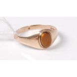 A 9ct tigers eye ring, the oval tigers eye disc in a collet mount to tapering plain band,