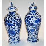 A pair of Chinese export stoneware blue & white vases and covers,