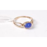A 9ct blue hardstone ring, the oval blue cabochon in collet mount,
