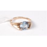 A topaz single stone ring, the round topaz, claw set to a tapering band hallmarked London 1969,