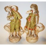 A pair of early 20th century Amphora Austrian pottery figural vases each in the form of a boy and a