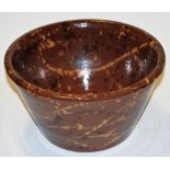 An early 20th century terracotta slip glazed bowl of tapered form, dia.