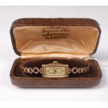 A lady's 9ct cased wristwatch on gilt metal strap