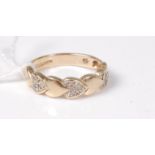 A 9ct diamond ring, half the band set with small heart shapes,