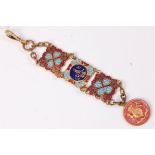 A gilt metal and enamel decorative fob,