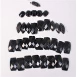 A quantity of jet beads of varying shapes