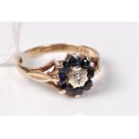 A 9ct sapphire and diamond cluster ring, the central illusion set diamond surrounded by diamonds,