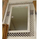 A white-washed wood and wrought metal framed wall mirror,