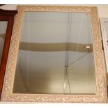 A modern framed and bevelled rectangular wall mirror,