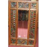 An Eastern joined carved and painted framed wall mirror,