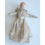 A 19th century German bisque headed miniature doll, wearing a simple dress and having bisque limbs,