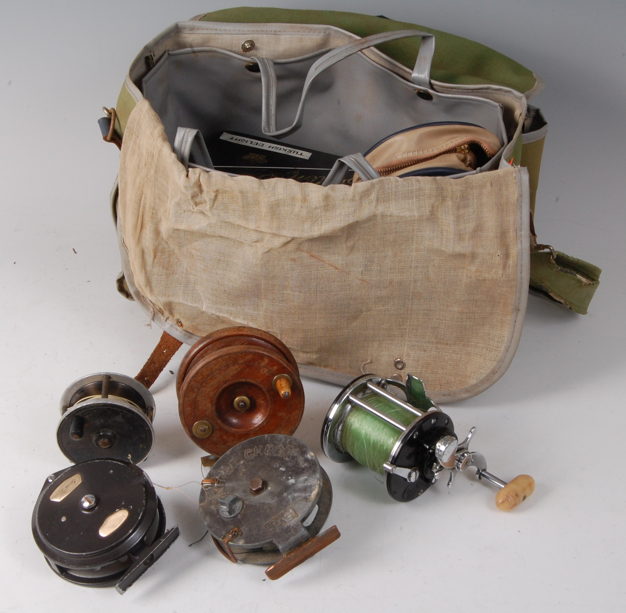 A fishing bag and contents to include a Penn 160 multiplier reel, a T.J.H.