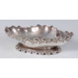 A late Victorian silver sweetmeat dish, of lozenge shape, having scroll border and foot rim, 11.