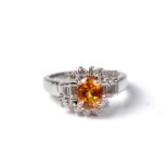 A 14ct yellow sapphire and diamond ring, the oval treated yellow sapphire approx. 7.2 x 6.