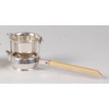 An Asprey & Co silver tea-strainer, of kettle shape with square cut ivory handle, Birmingham 1908,