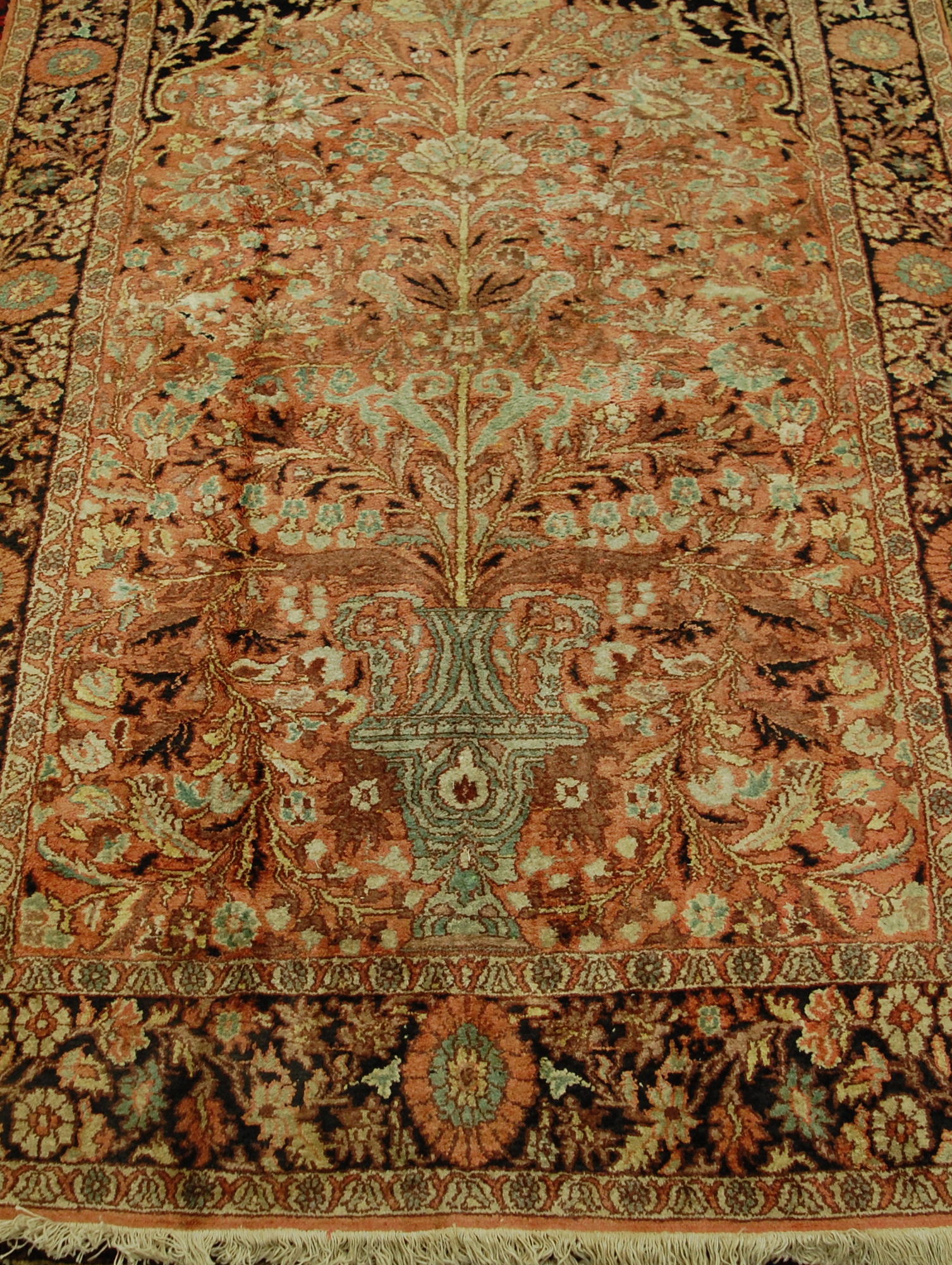 A Persian woollen peach ground carpet,