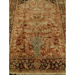 A Persian woollen peach ground carpet,