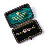 A diamond set riding crop brooch,