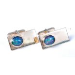 A pair of 9ct gold opal set cufflinks, the oval opal cabochons in rubover mounts,