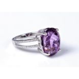 An amethyst and diamond ring, the oval amethyst approx. 13.2 x10.