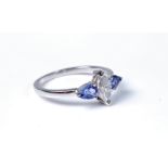 A 14ct three stone tanzanite and diamond ring, the central marquise diamond, estimated approx. 0.