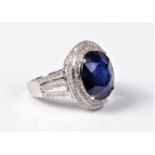 A treated sapphire and diamond ring, the oval sapphire, approx. 12.9 x 11.