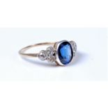 An 18ct synthetic sapphire and diamond ring, the oval sapphire, approx. 8.