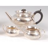 A late Victorian silver three-piece teaset, comprising teapot, twin handled sugar and cream,