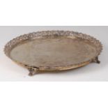 A South American white metal salver, having a pierced scroll leaf rim,