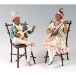 A pair of rare Goldscheider style majolica figures, modelled as African-American banjo players,