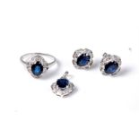 A 9ct white gold sapphire and diamond suite, comprising a ring of an oval sapphire approx. 7.