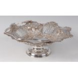A late Victorian silver pedestal basket, having swing carry handle,