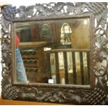 A Continental leaf carved and framed wall mirror,