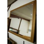 A modern gilt framed rectangular wall mirror,