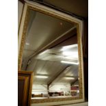 A modern gilt composition framed and bevelled wall mirror,