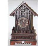 A late 19th century Continental oak cased cuckoo clock, of architectural outline,