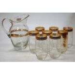 A 1950s clear glass lemonade set, etched with swags and bows, heightened in gilt,