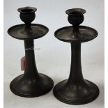 A pair of Arts & Crafts hammered pewter table candlesticks,