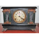 A late 19th century American ebonised cased mantel clock, of architectural form,