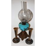 A late Victorian oil lamp, having etched globular glass shade above a blue porcelain reservoir,