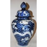 A large Chinese style stoneware blue and white vase and cover, of bluster form,